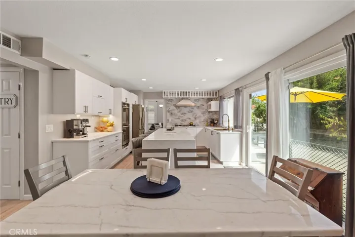 Shot from additional kitchen dining/office space towards kitchen.