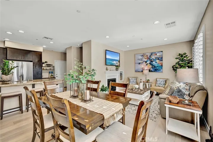 Fireplace in living room that is open to the spacious dining room and open to the gourmet kitchen