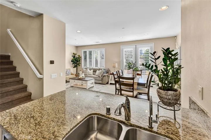 Kitchen looking into dining room and living room. ON left is the staircase to the second floor