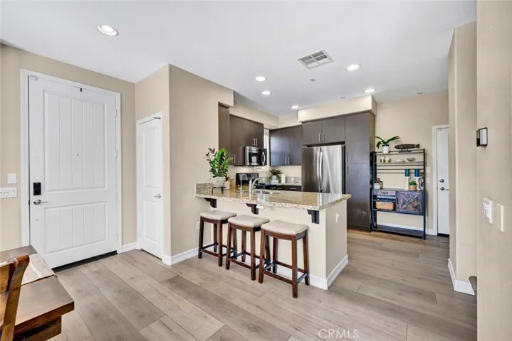 Kitchen has granite countertops and a breakfast bar