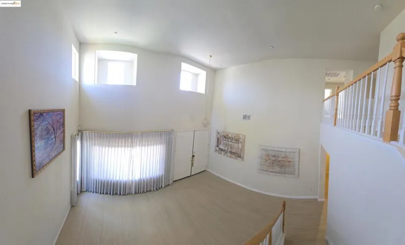 Entrance foyer with plenty of natural light, wood finished floors, and high vaulted ceiling