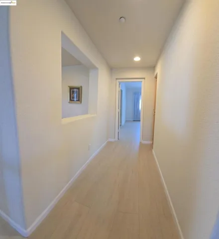 Hall featuring light wood finished floors and recessed lighting