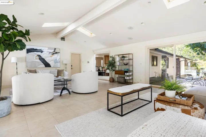 Living area featuring a skylight and tile patterned floors