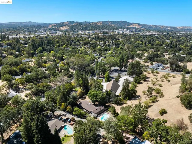 Aerial overview of property's location featuring mountains and a pool