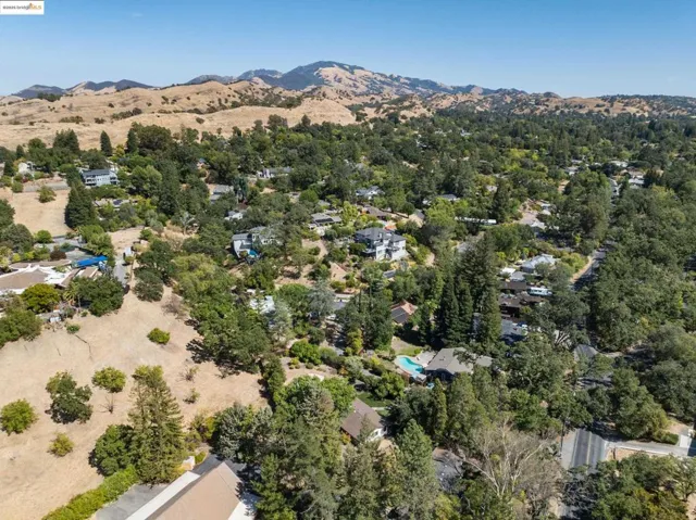 Aerial overview of property's location featuring a mountainous background