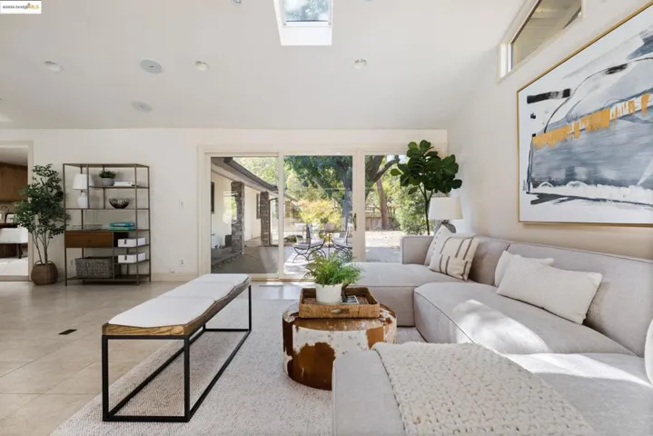 Tiled living area featuring a skylight and recessed lighting