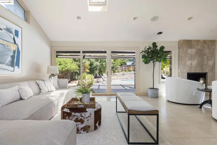 Living room with light tile patterned flooring, a fireplace, and recessed lighting