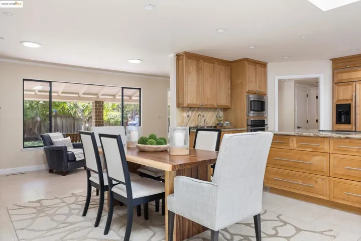 Dining space with recessed lighting, light tile patterned flooring, and crown molding