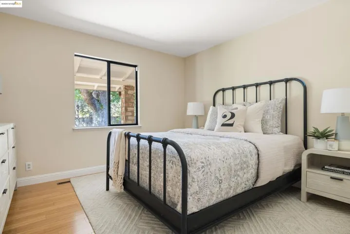 Bedroom featuring light wood-style floors and baseboards