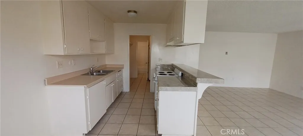 kitchen into pantry/laundry room to hall bath