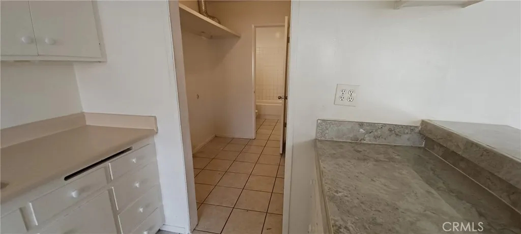 kitchen into pantry/laundry room to hall bath