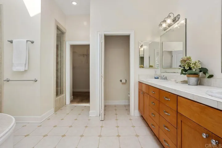Double sinks, walk-in closet, Oval tub & walk-in shower.