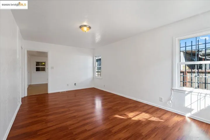 Spare room featuring wood finished floors