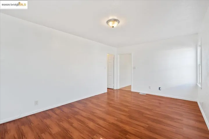 Empty room with wood finished floors and baseboards