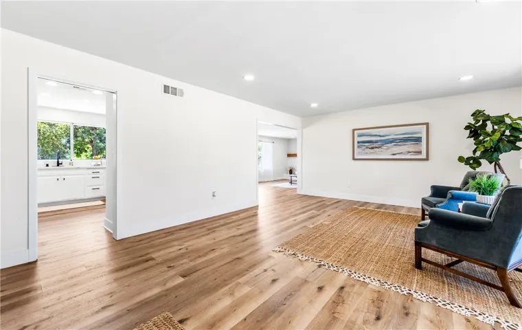 The living room flows seamlessly into the kitchen, dining and family rooms in a perfect circle of connectivity, with backyard just beyond, ideal for effortless entertaining.