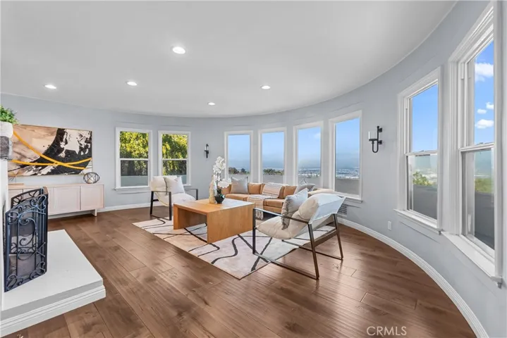 The living room brings the Art Deco influence of the era with the circular wall and dramatic views from the picture windows that frame the Pacific Ocean, the harbors, mountains, and the city.