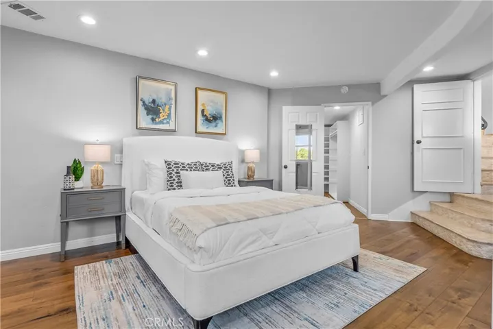 The elegant primary bedroom is a spacious suite where the Art Deco design continues.