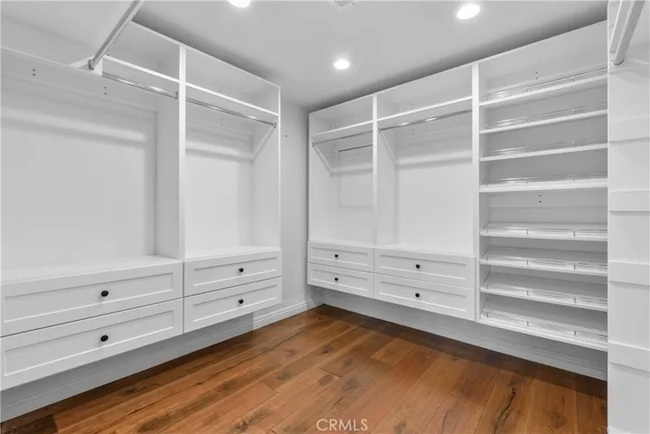 The suite includes a large customized walk-in closet with built-ins, and an oasis in the spa-like bath.