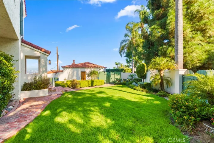The lush lawn and landscaping add the home's charm.