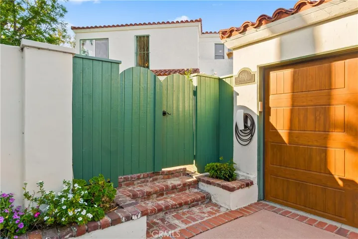 The gated private entry is a welcoming feature to the home.