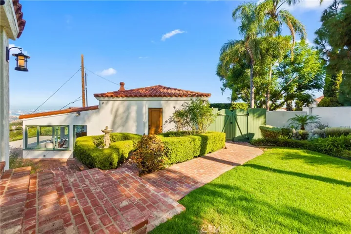 The lush lawn and landscaping add the home's charm.
