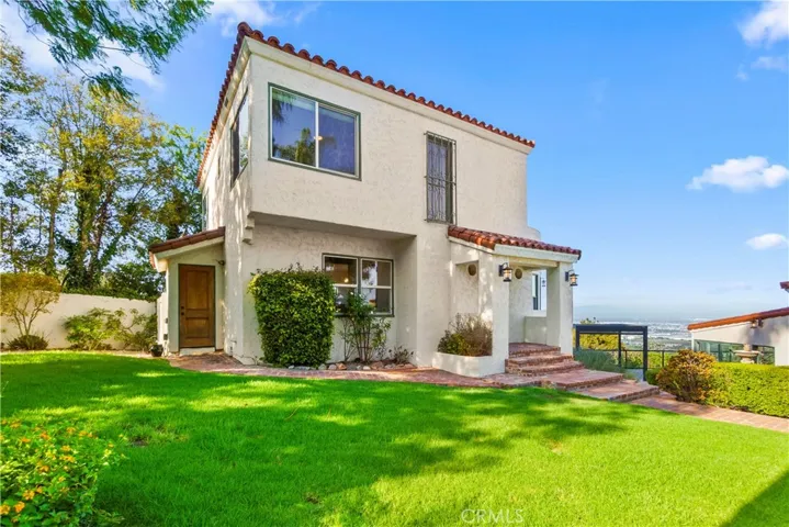 The lush lawn and landscaping add the home's charm.