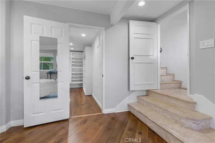 The suite includes a large customized walk-in closet with built-ins, and an oasis in the spa-like bath.