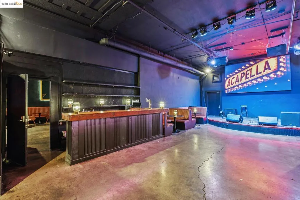 Misc room with concrete flooring and a towering ceiling
