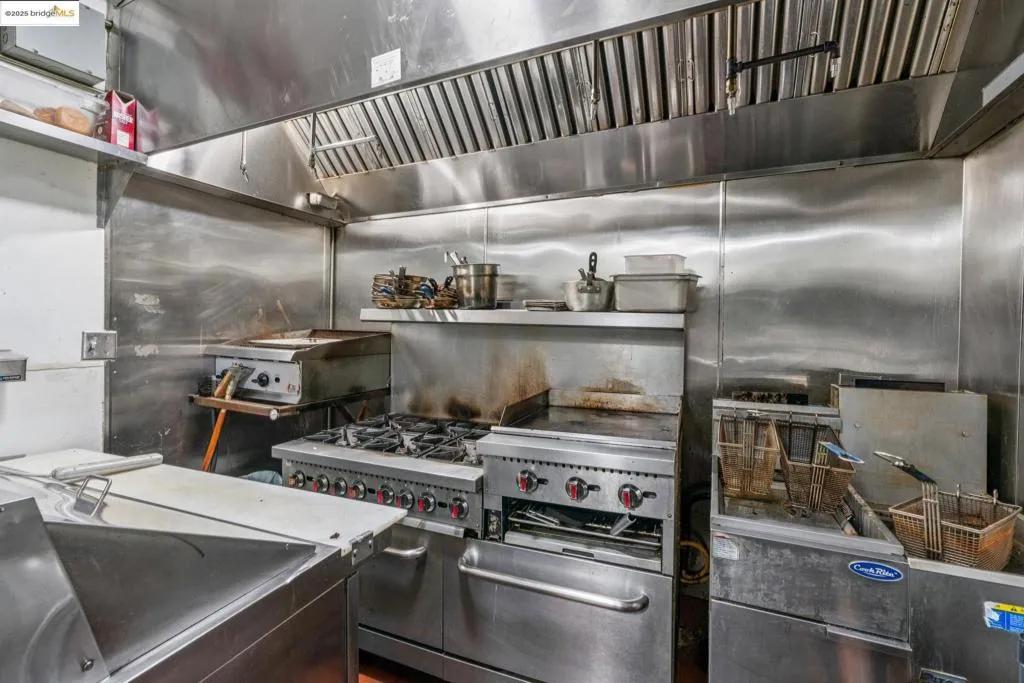 Kitchen featuring custom exhaust hood
