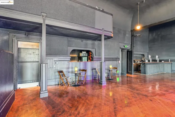 Kitchen featuring wood-type flooring and a high ceiling