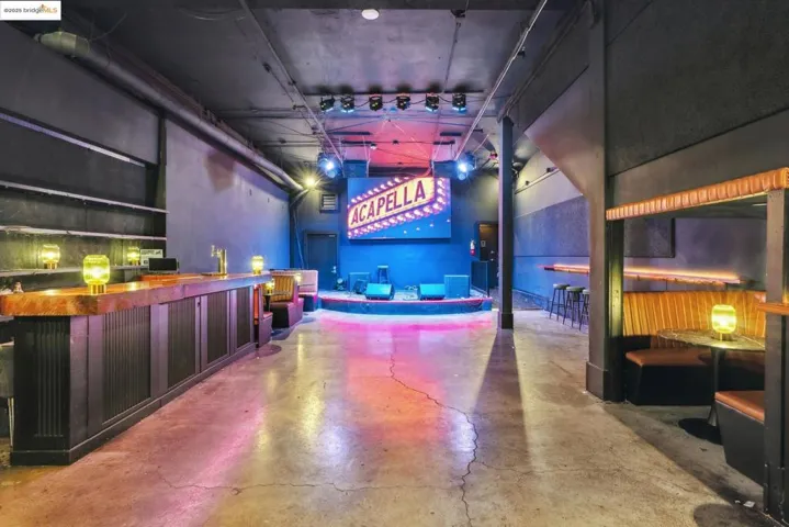 Misc room with concrete flooring, a high ceiling, and a community bar