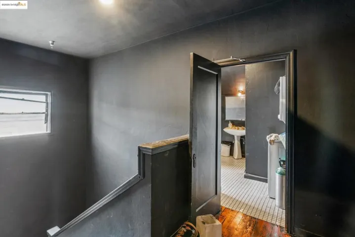 Hallway featuring dark wood-type flooring and a sink