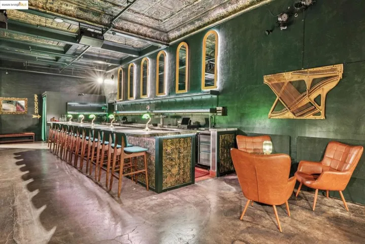 Bar area with finished concrete floors, beverage cooler, and an ornate ceiling