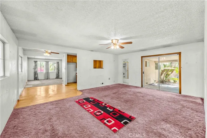 VIEW FROM FAMILY ROOM TO KITCHEN AND LIVING ROOM.