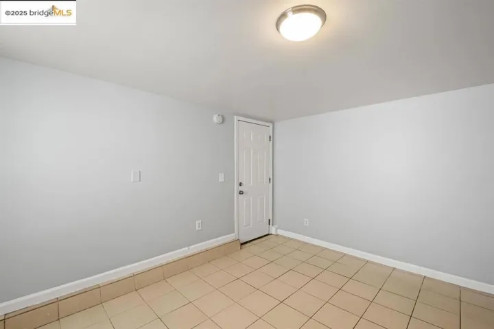 Unfurnished room featuring baseboards and light tile patterned floors