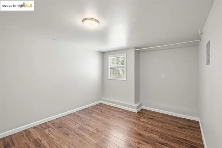 Spare room featuring wood finished floors and baseboards