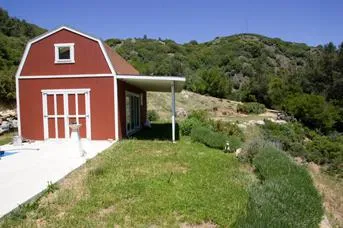 Charming red barn with mountain views, captured before the fire.