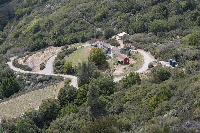 Sprawling mountain retreat with home, barn, and vineyard, shown before the fire.