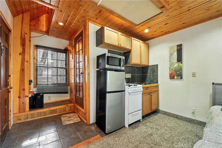 Facing northwest: Detached ADU entryway + closet and door to 3/4 bathroom & Kichenette