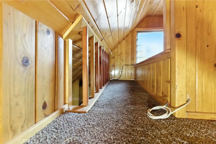 Facing west: detached ADU loft looking towards window & bathroom ceiling on right hand side