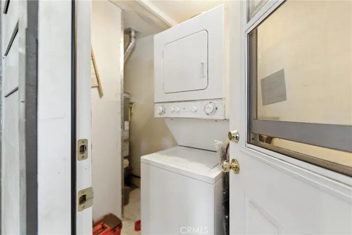 Separate laundry room with included stackable washer and dryer outside back door