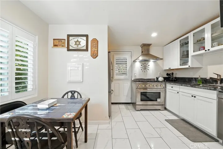 Main home kitchen and dining room facing east towards back door