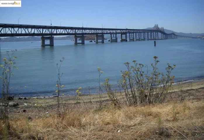 Water view with a notable bridge and a pier