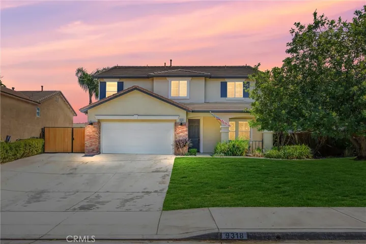 Enhanced front with wide driveway and gated storage
