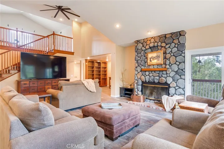 office with built-in bookcase and stairs to the loft
