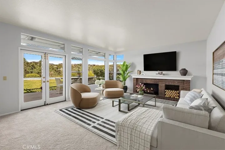 Sit and relax is this warm and comfortable family room with fireplace and open views of backyard