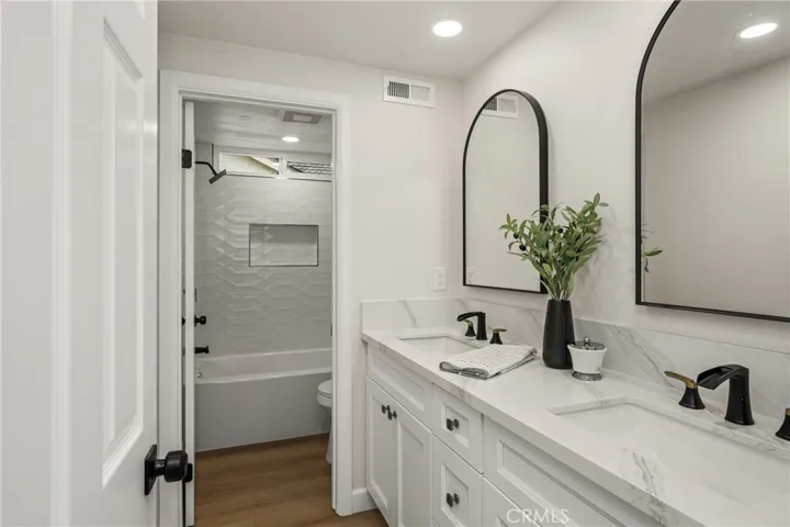 Upstairs hall bathroom showing bathtub and toilet area.
