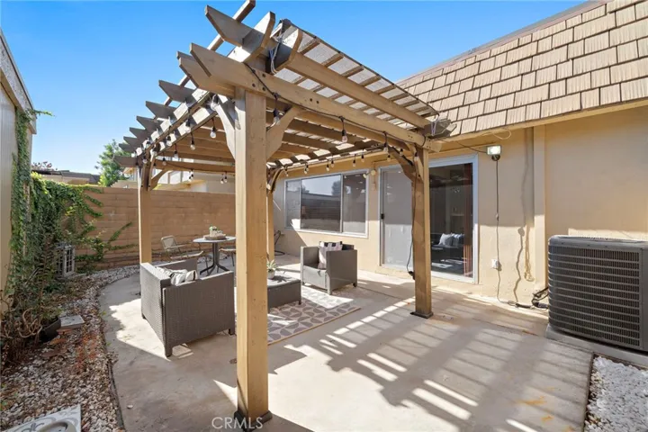 Large Private Patio with Patio Cover, Block Wall Fencing and Direct Access to 2 Car Garage