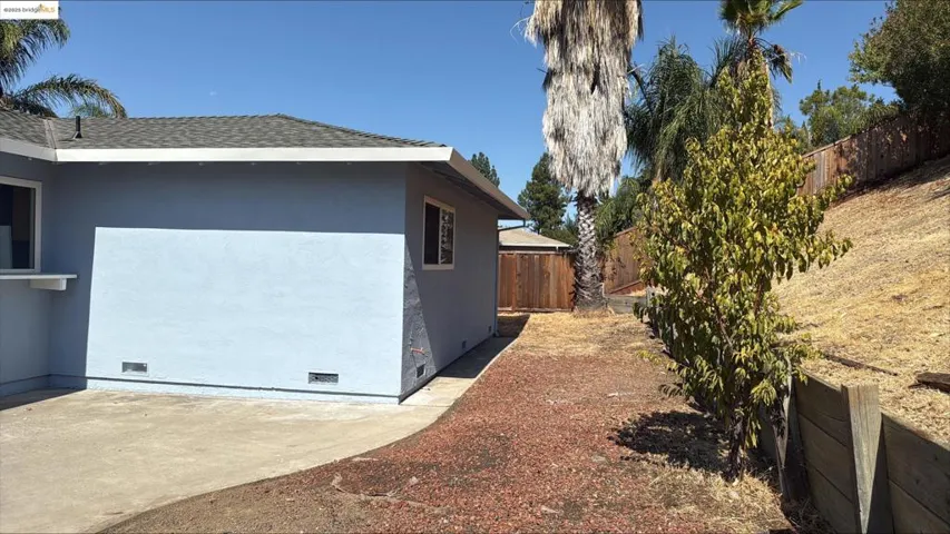View of side of home featuring crawl space, roof with shingles, and stucco siding
