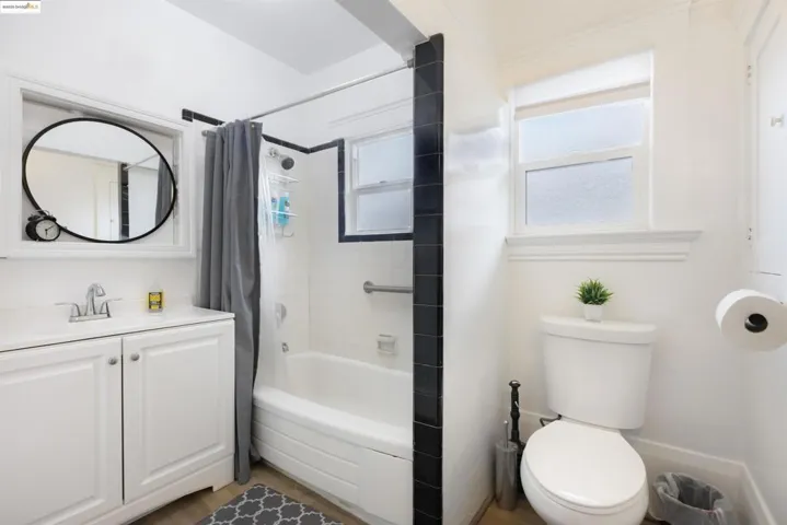 Full bath with shower / tub combo with curtain and vanity